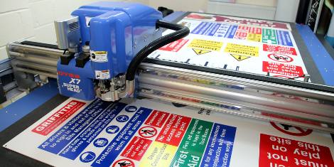 Safety signs being cut on DYSS X7-1325C 