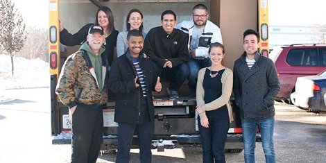 The Orbus team with LCpl Steven Collins, after loading the truck with boxes of donated toys