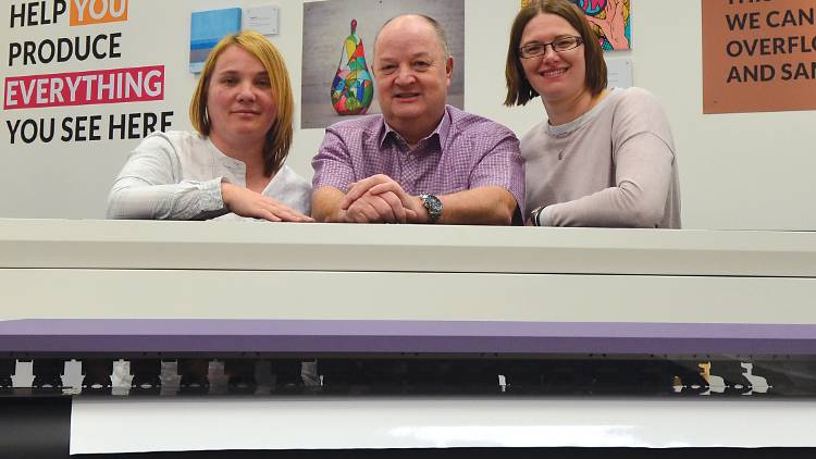 Signmster’s Sam Kehoe (L) and Lucy Ratcliffe (R) with Hybrid’s John de la Roche and one of the company’s new Mimaki printers.